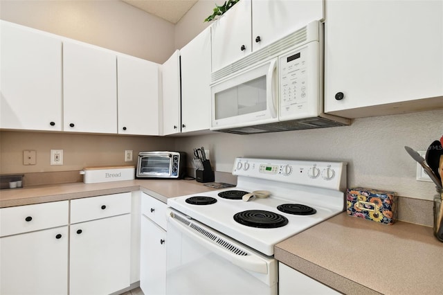 kitchen with white cabinets and white appliances