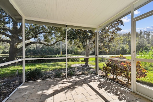 1687 Starling Dr, Tarpon Springs, FL 34689 - unfurnished sunroom featuring view of wooded area