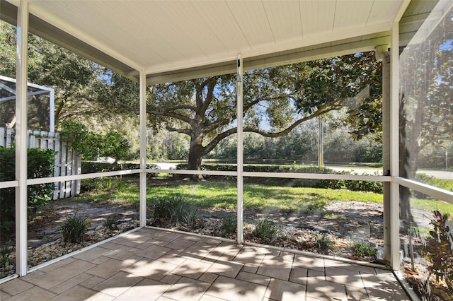 1687 Starling Dr, Tarpon Springs, FL 34689 - unfurnished sunroom with view of wooded area