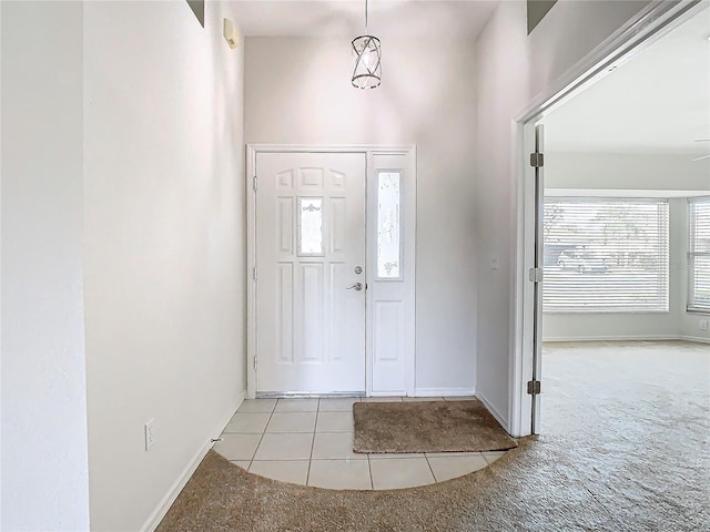 view of carpeted foyer entrance