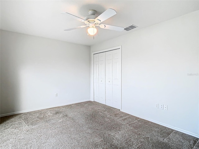 unfurnished bedroom featuring ceiling fan, a closet, and carpet floors