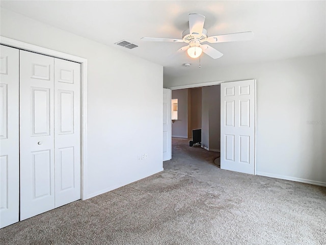 unfurnished bedroom with carpet flooring, ceiling fan, and a closet