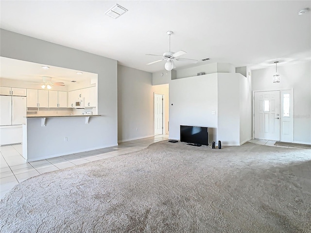 unfurnished living room featuring light carpet