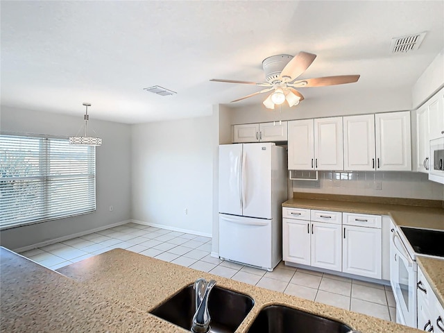 kitchen featuring white cabinetry, ceiling fan, hanging light fixtures, and white appliances