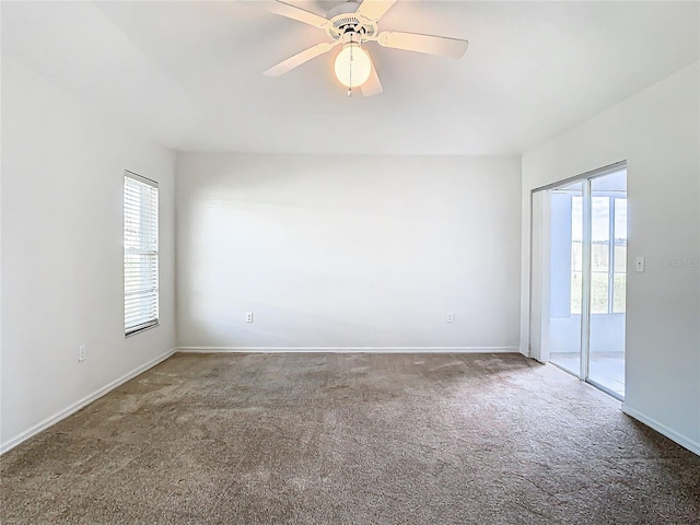 carpeted empty room featuring ceiling fan