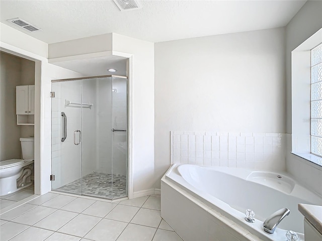 bathroom featuring tile patterned flooring, independent shower and bath, a textured ceiling, and toilet