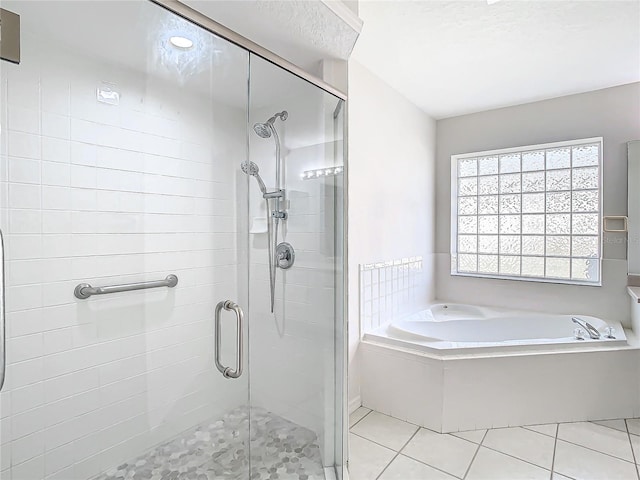 bathroom with tile patterned flooring and independent shower and bath