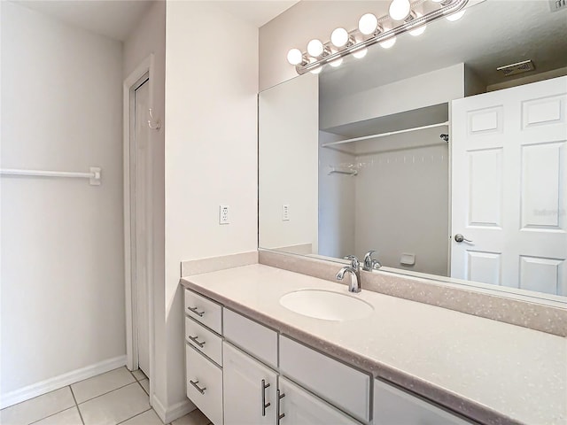 bathroom featuring tile patterned flooring and vanity