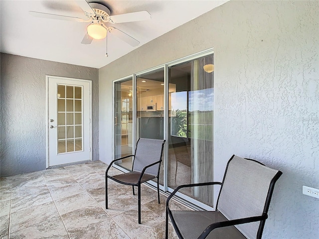 view of patio featuring ceiling fan