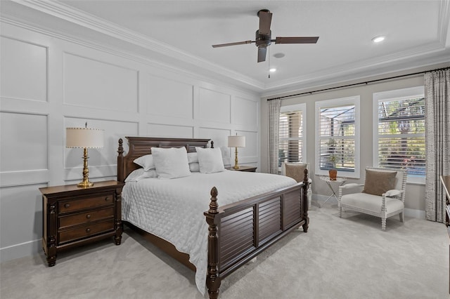 bedroom with ceiling fan, ornamental molding, and light carpet