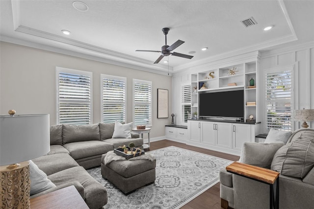 living room featuring plenty of natural light, hardwood / wood-style floors, and ornamental molding