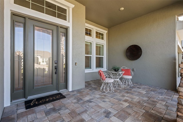 view of exterior entry featuring a porch