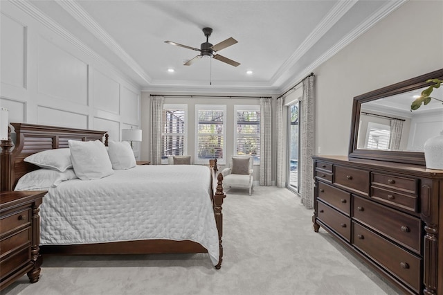 carpeted bedroom with ceiling fan, a raised ceiling, ornamental molding, and access to outside