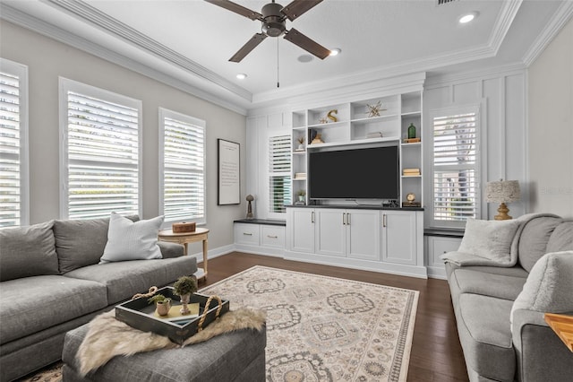 living room with a wealth of natural light, ceiling fan, dark hardwood / wood-style floors, and ornamental molding