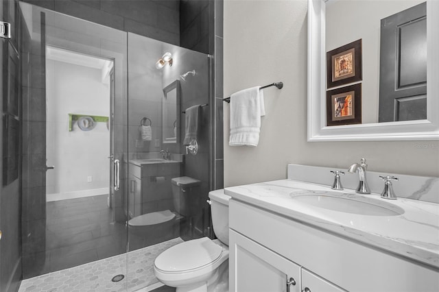 bathroom with vanity, toilet, and a shower with door