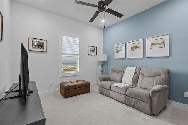 carpeted living room with ceiling fan