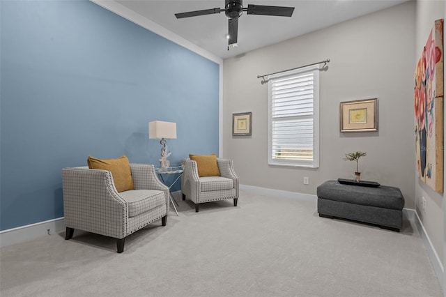 living area with ceiling fan and light colored carpet