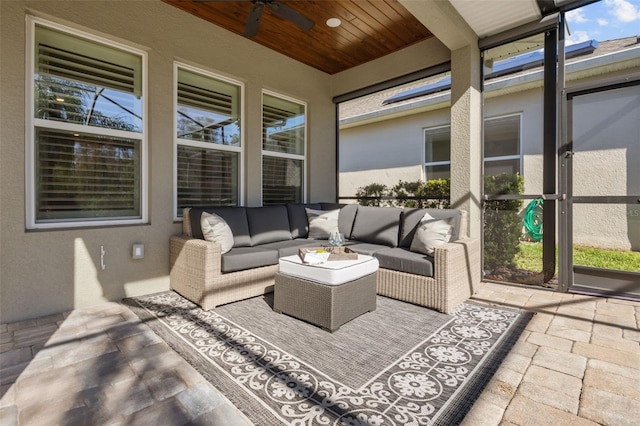 sunroom / solarium featuring ceiling fan and wood ceiling