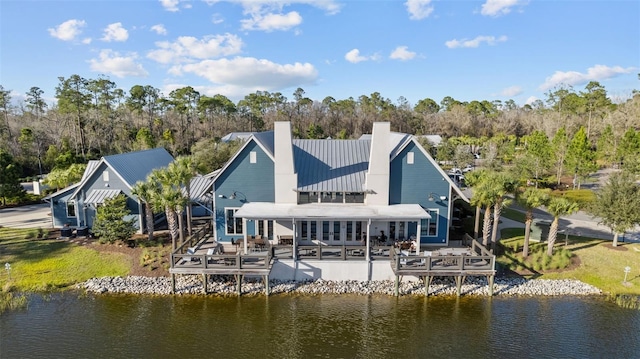 back of house featuring a deck with water view