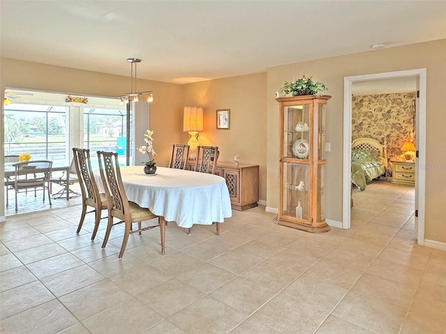 tiled dining room featuring an inviting chandelier