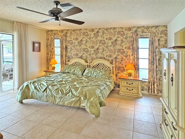 tiled bedroom with a textured ceiling and ceiling fan