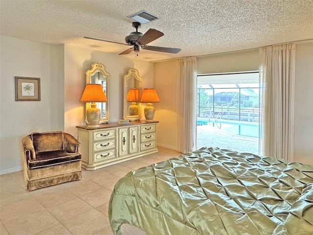 tiled bedroom with ceiling fan, a textured ceiling, and access to outside