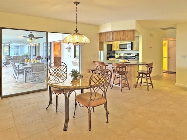 dining area featuring ceiling fan and light tile patterned floors