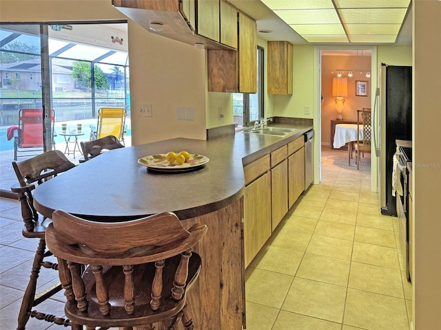 kitchen with light tile patterned floors, stainless steel appliances, and sink