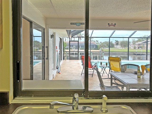 sunroom with a water view and plenty of natural light