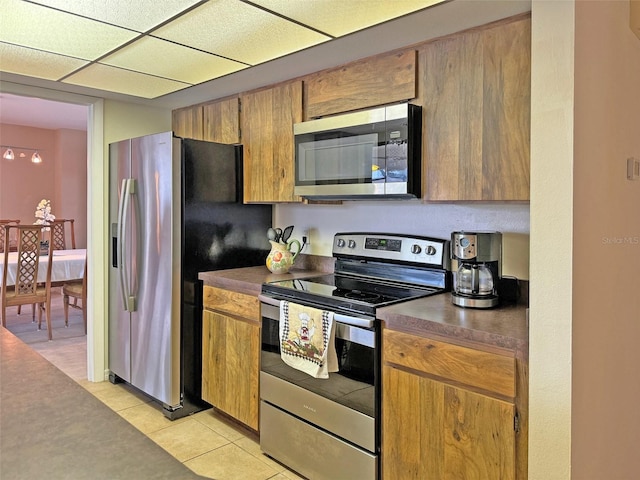 kitchen featuring light tile patterned floors and stainless steel appliances