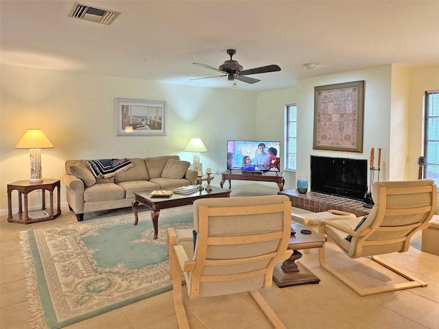 tiled living room with ceiling fan and a healthy amount of sunlight