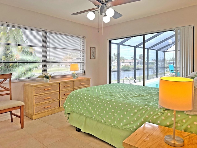 bedroom featuring access to exterior, ceiling fan, a water view, and light tile patterned flooring