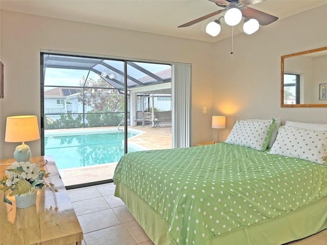 bedroom featuring access to exterior, light tile patterned floors, multiple windows, and ceiling fan