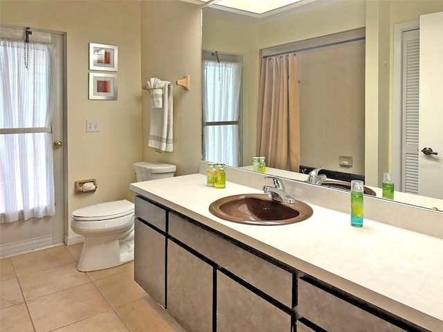 bathroom featuring tile patterned floors, vanity, and toilet