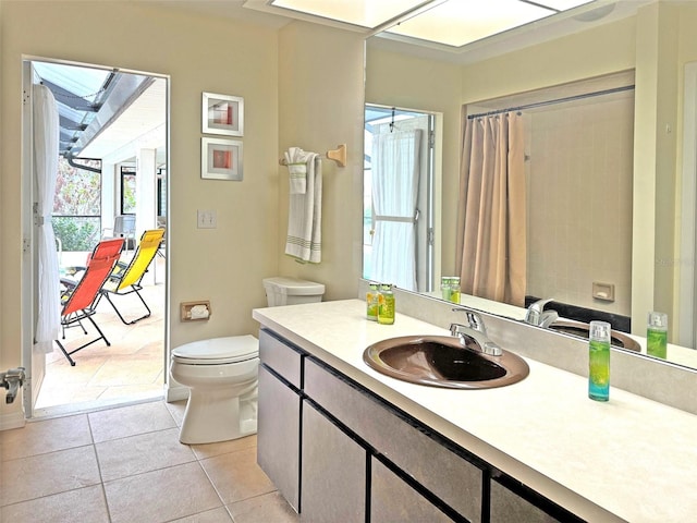 bathroom with tile patterned flooring, vanity, and toilet