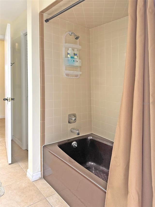 bathroom with shower / bath combination with curtain and tile patterned floors