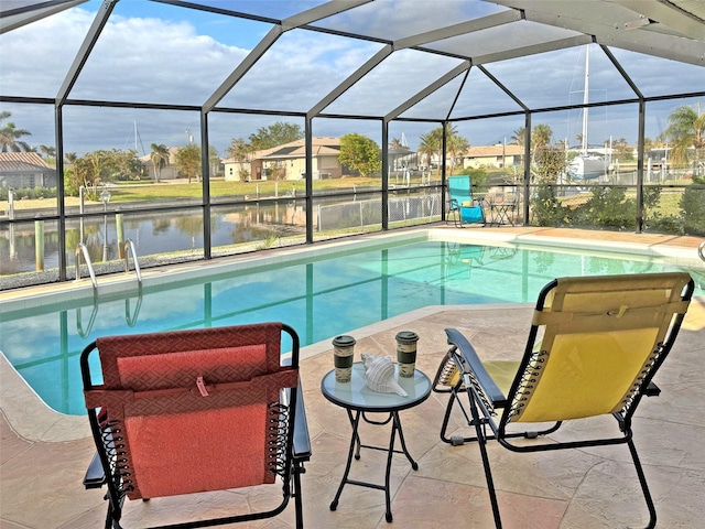 view of swimming pool with glass enclosure, a patio area, and a water view