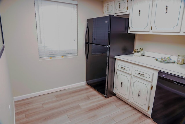 kitchen featuring white cabinets, light wood-type flooring, beverage cooler, and black appliances