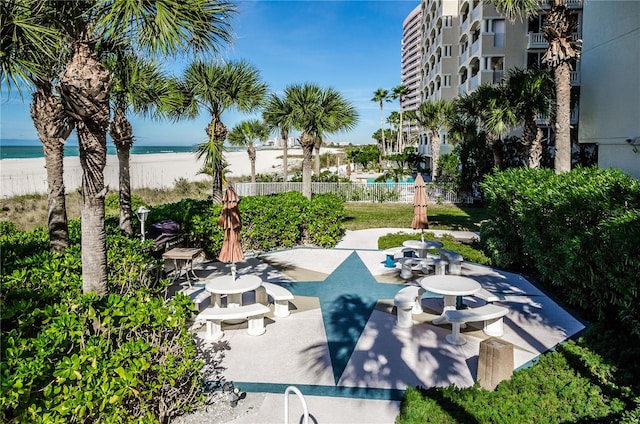 surrounding community featuring a water view and a patio area