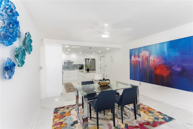 dining space featuring ceiling fan and ornamental molding