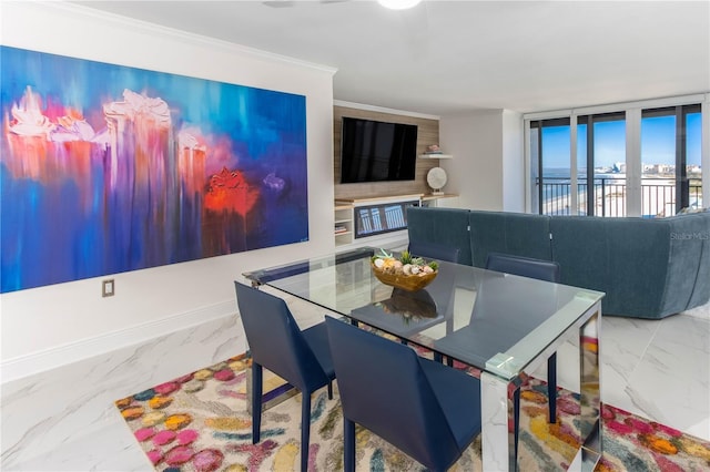 dining space with expansive windows and ornamental molding