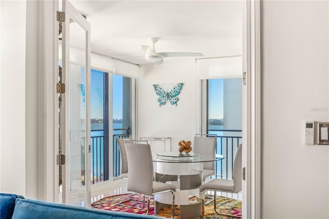 interior space with ceiling fan and a water view