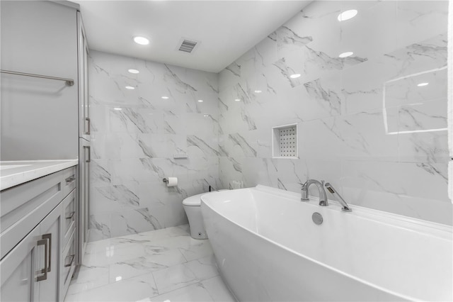 bathroom with vanity, toilet, and a bathtub