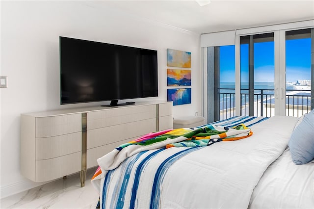 bedroom featuring floor to ceiling windows and access to exterior