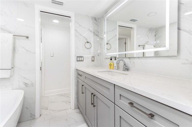 bathroom featuring vanity and a tub