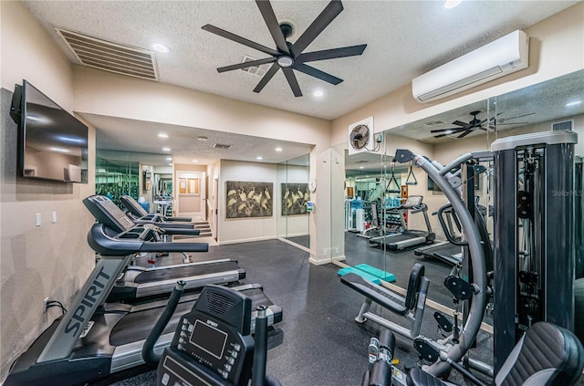 exercise room with ceiling fan, a textured ceiling, and a wall unit AC