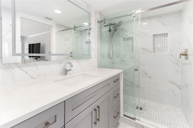 bathroom with vanity and a shower with shower door