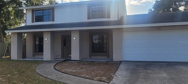 view of front of house featuring a porch and a garage