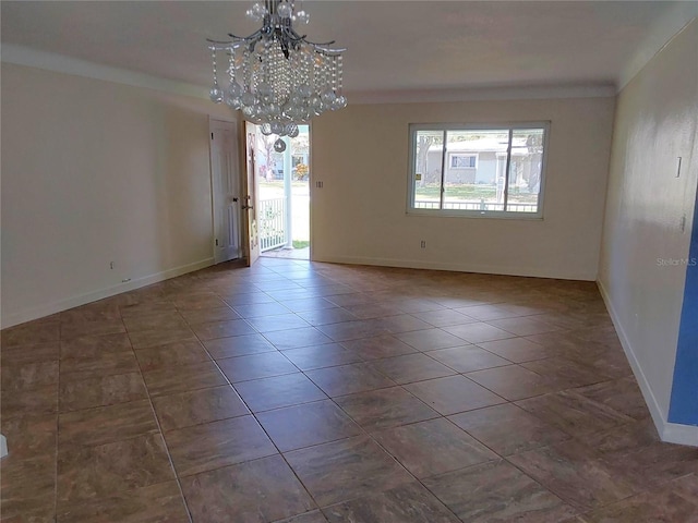 spare room featuring ornamental molding and a notable chandelier