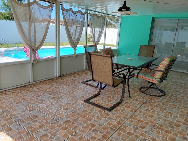 sunroom / solarium featuring ceiling fan